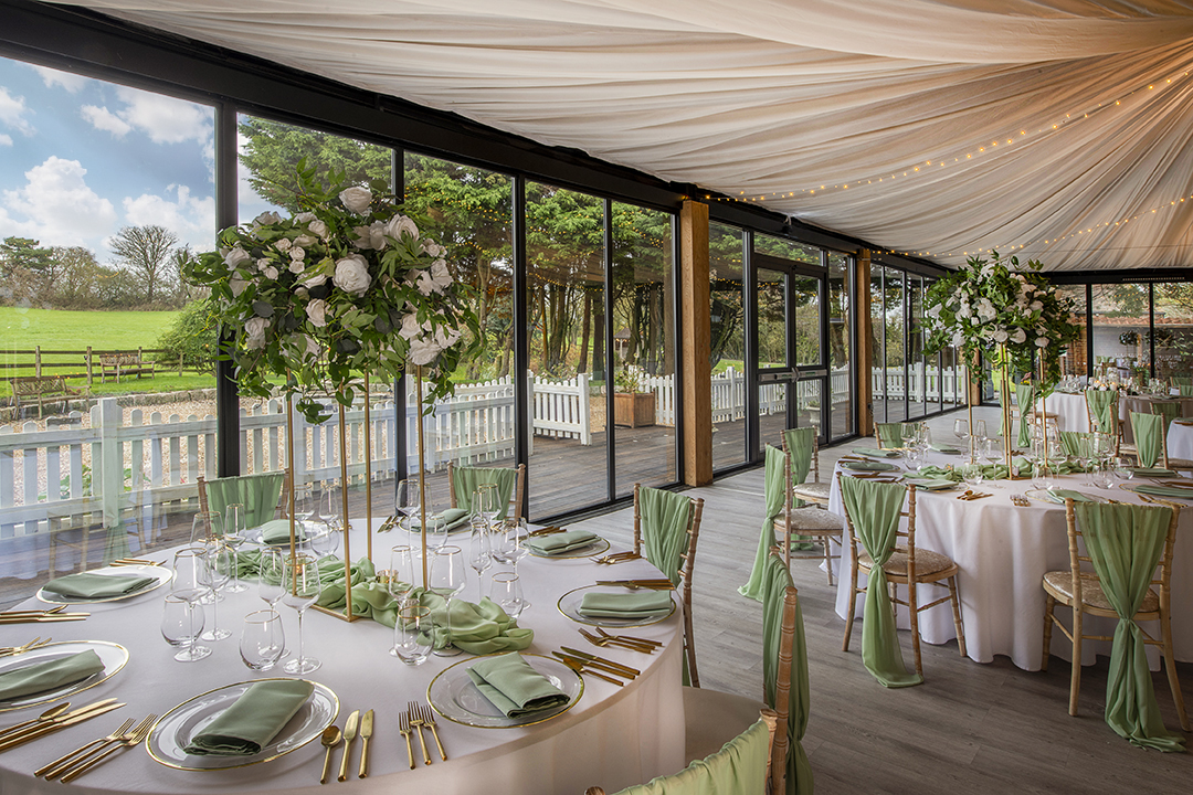 A picture of the Dutch Barn set up for a traditional wedding breakfast at Solton Manor, Dover