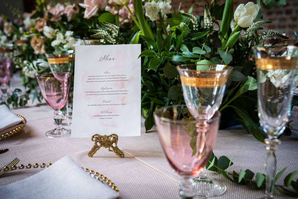 A menu stands on a beautifully laid table within Salton Manor near Dover