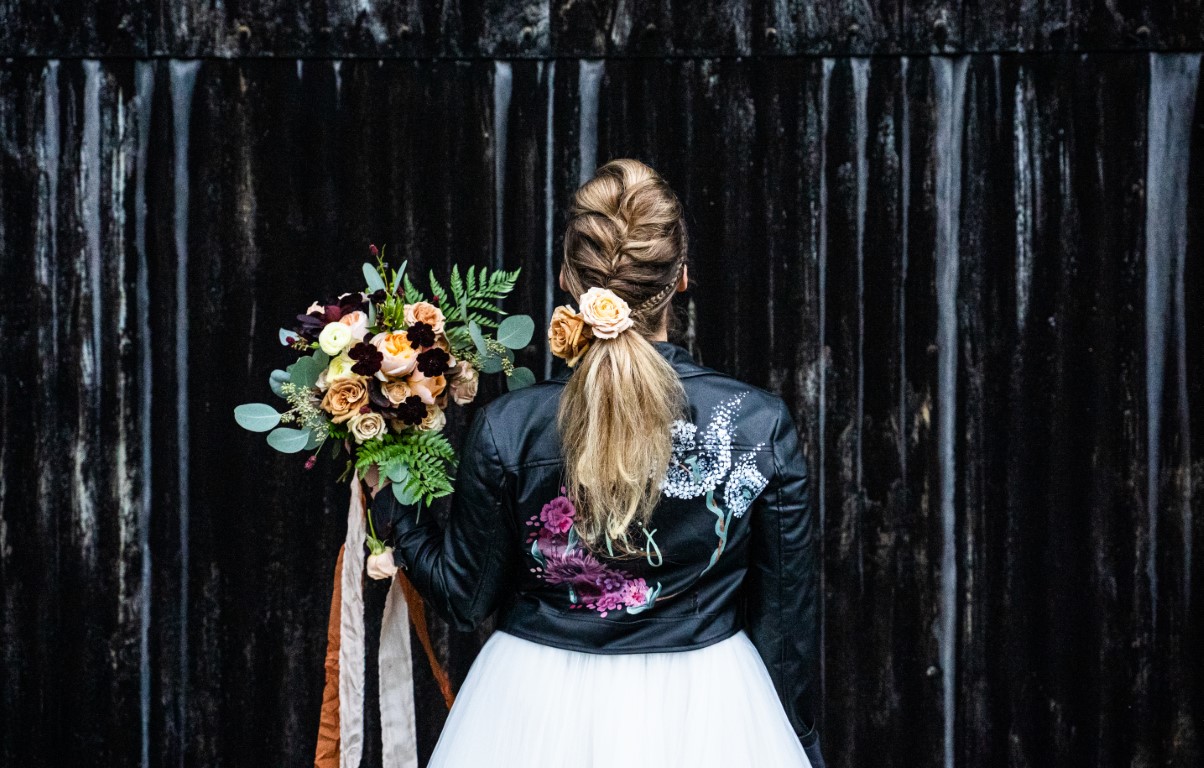 A bride stands in front of the Dutch Barn at Solton Manor