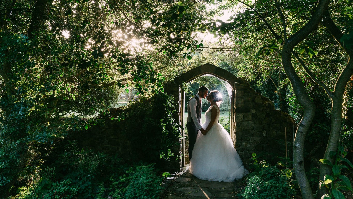 A couple stand under the arch in Godric's Garden at Solton Manor in Dover, Kent