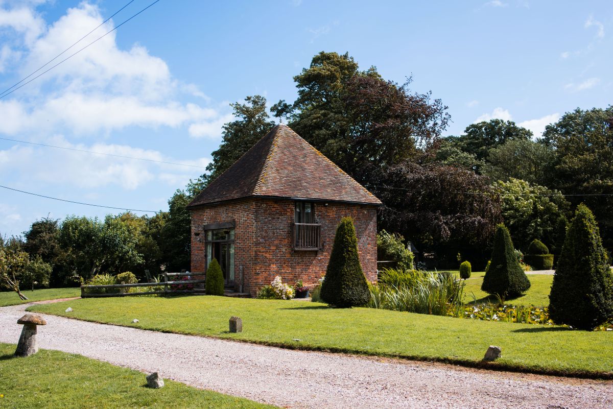 The Dovecote Cottage at Solton Manor in Kent from the Ornamental Pond
