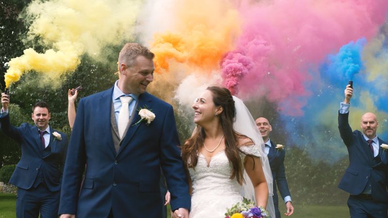 a couple at solton manor who choose smoke bombs over confetti in the gardens of the 800 year old mansion.