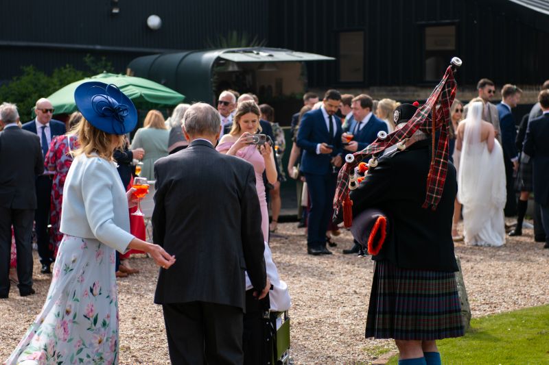vintage horse box bar serving drinks during a wedding reception at solton manor, a kent country manor wedding venue offering stylish outdoor rustic bar setups for weddings and celebrations