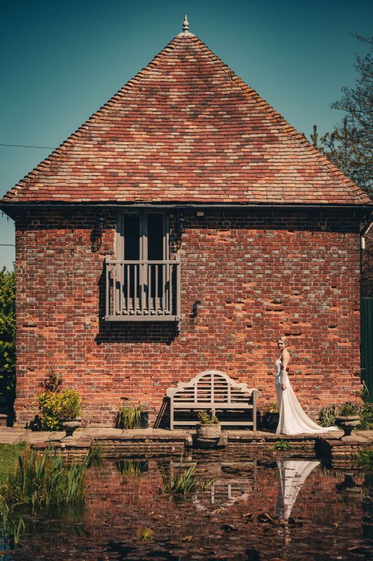the dovecote cottage overlooking the moat at solton manor, in the garden of kent, england