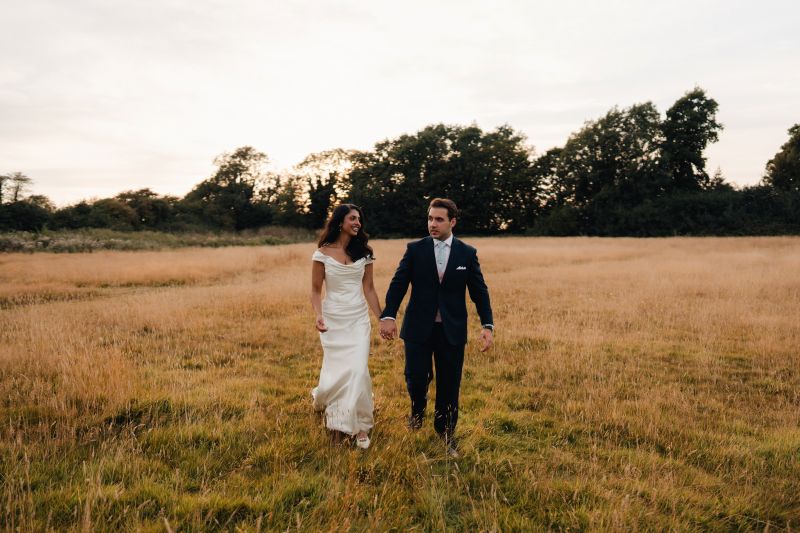 A real couple, Shreya and John in the Meadow at Solton Manor, wedding venue near Dover, Kent, England