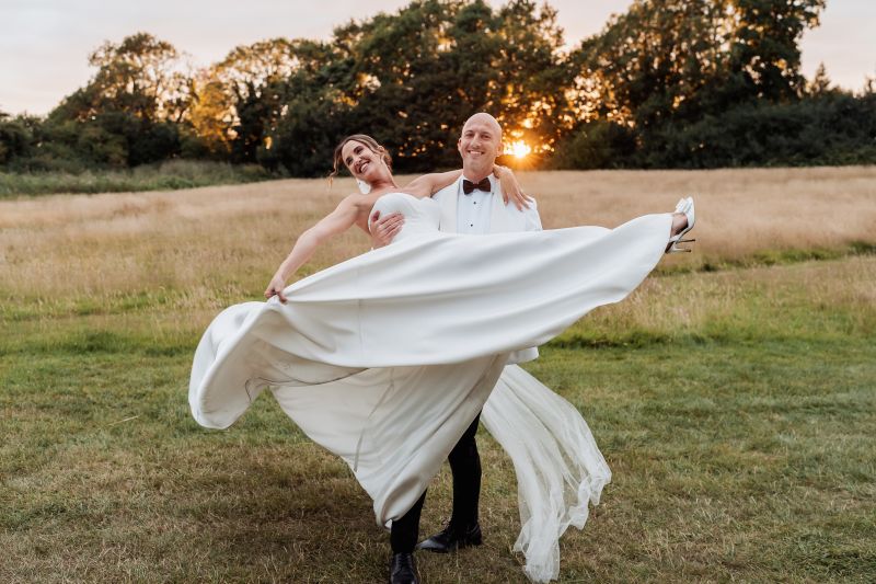 tom picks up beth, a real couple, for their couple shots in the famine field meadow at solton manor, east langdon, dover, kent, england